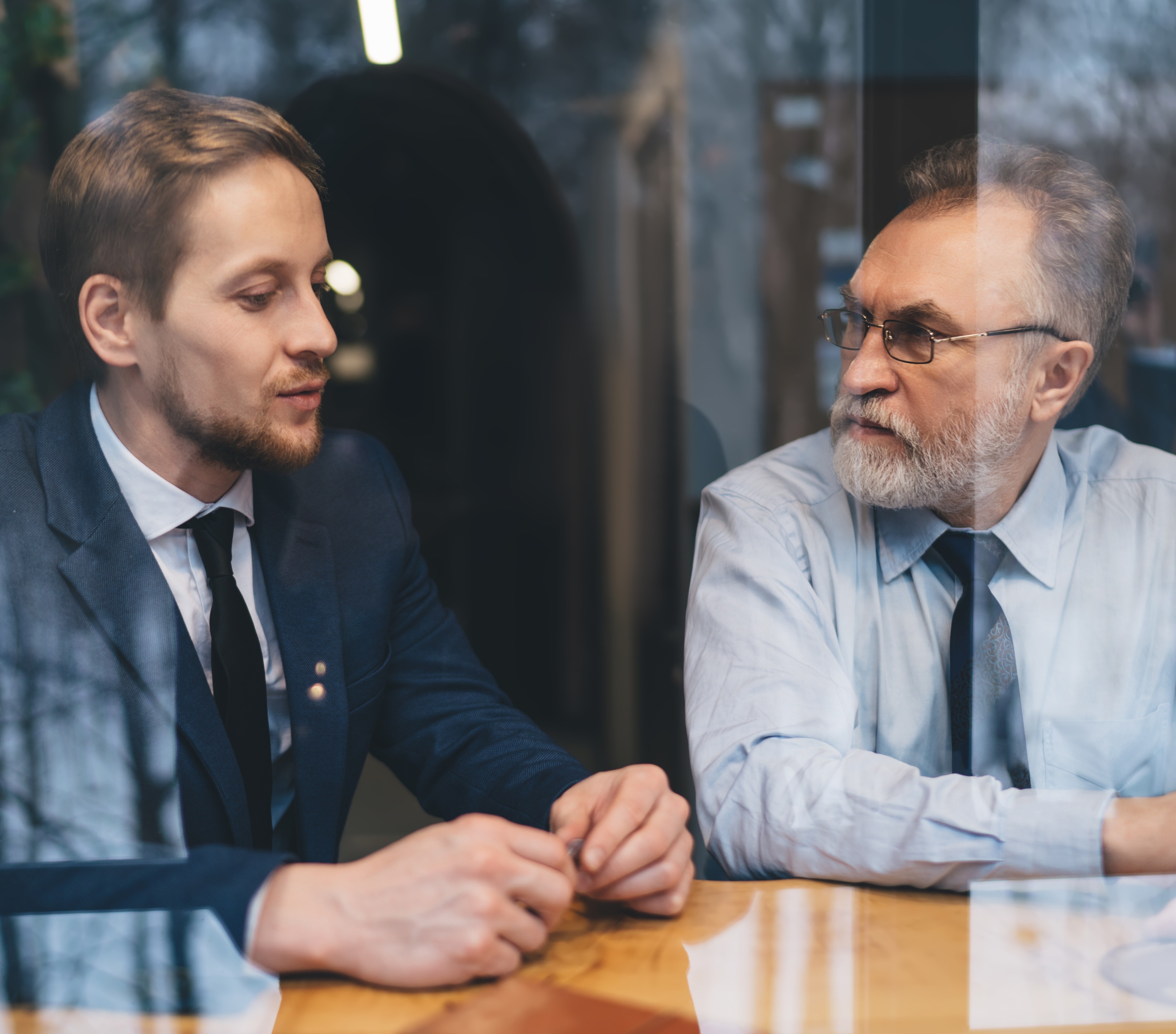 focused-businessmen-discussing-new-project-while-s-2023-11-27-05-17-02-utc